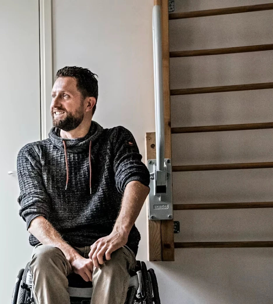 Gert-Jan Oskam shown in a sweater sitting in a wheelchair close to a wall